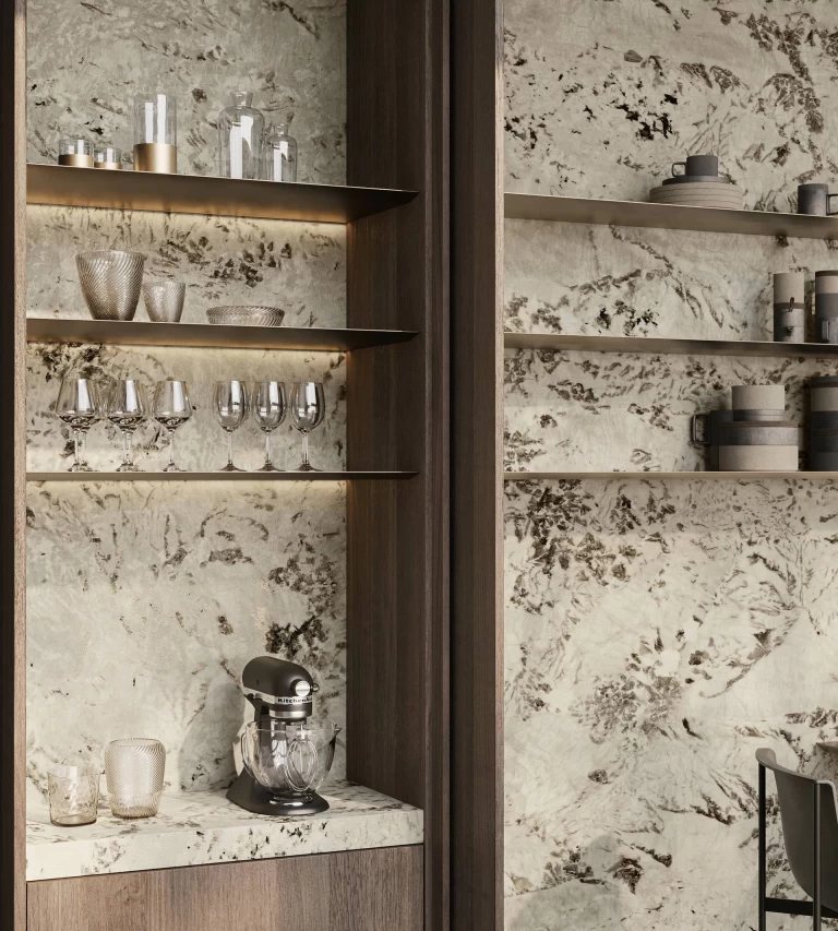 Close-up of kitchen shelves with glassware and accessories, Alpinus marble-effect cladding and dark wood finishes.