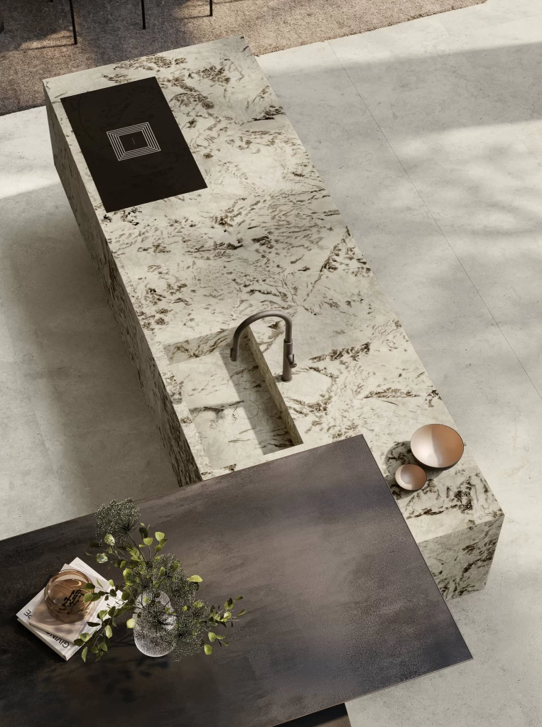 Detail of the dining area with suspended peninsula, modern seating and Alpinus marble-effect cladding by Atlas Plan.