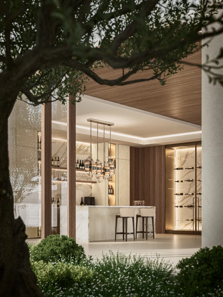 Vista esterna del wine bar tra il verde, con bancone e rivestimenti in Calacatta Oro per un'atmosfera raffinata ed esclusiva.