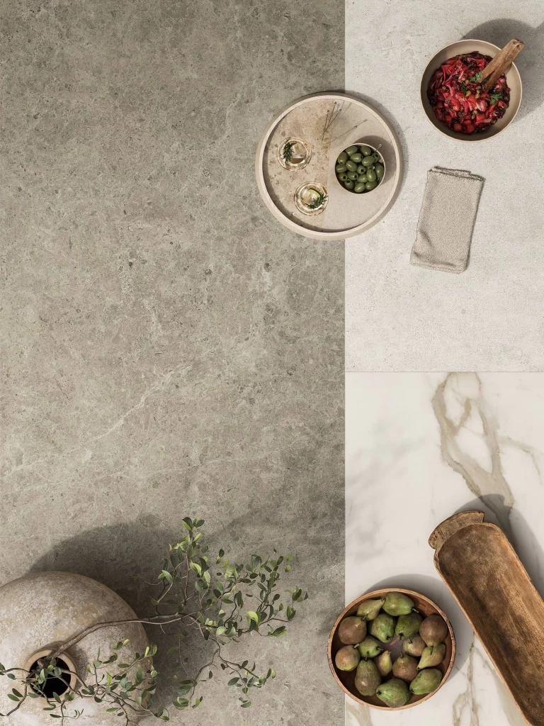 Material composition pairing a Nyra Mist surface with natural wood, white marble, and designer accessories.
