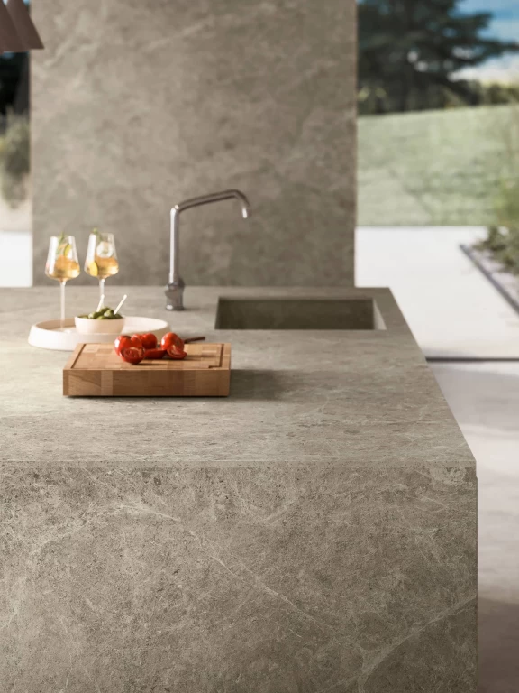 Close-up of the integrated sink within the Nyra Mist island, with a sleek modern faucet and smooth surface texture.