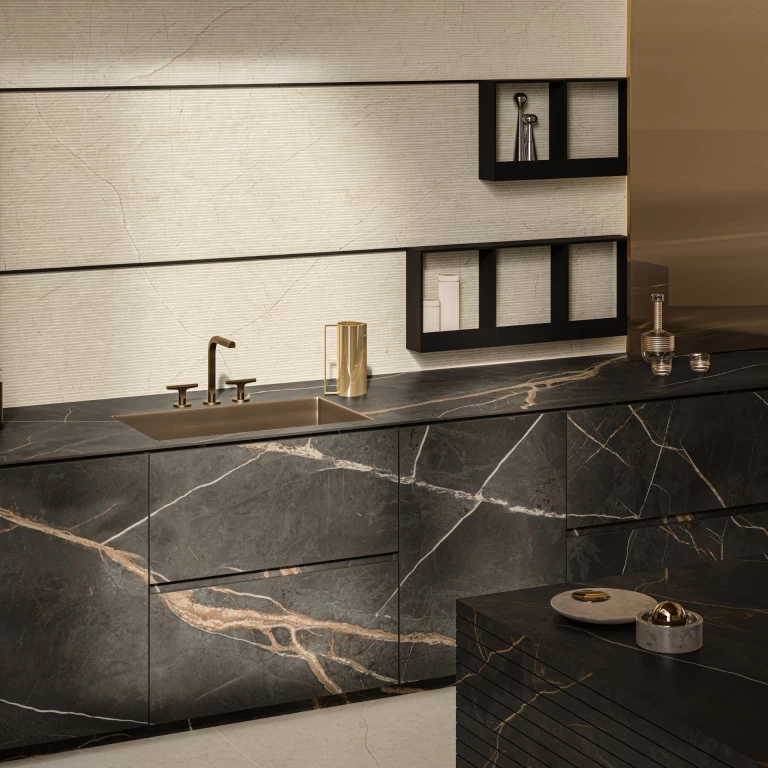Cucina moderna con top e ante in gres effetto marmo Sahara Dark, abbinati a un rivestimento a parete dai toni avorio per un ambiente elegante e contrastato.