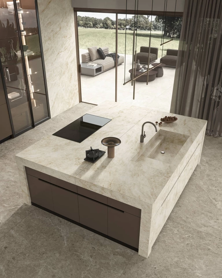Top-down view of the Atlas Plan Taj Mahal White kitchen island with hob, integrated sink and outlook onto the terrace.
