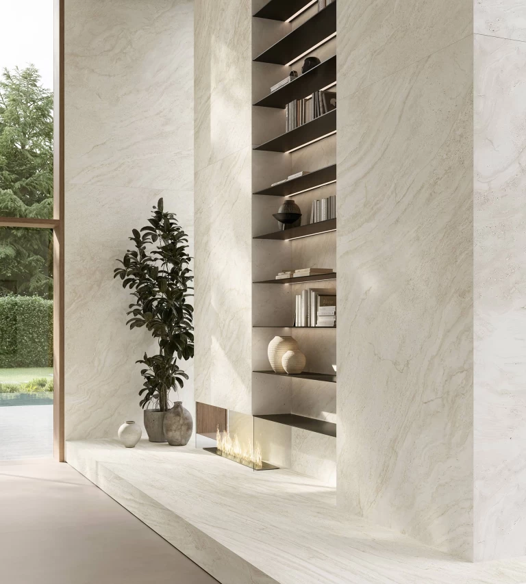 Side view of the fitted wall with bookcase, modern fireplace and Travertino Halo White cladding.