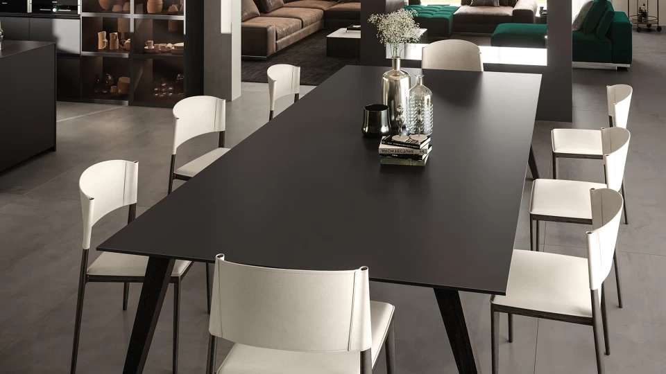 Black table in Atlas Plan porcelain stoneware with white chairs