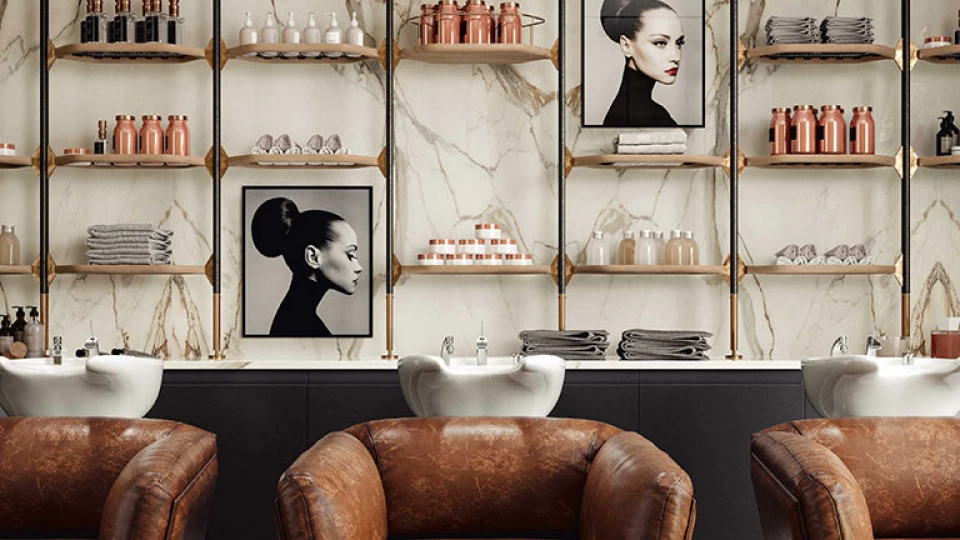 Brown armchairs and wall covering with images with Calacatta Imperiale polished porcelain tiles