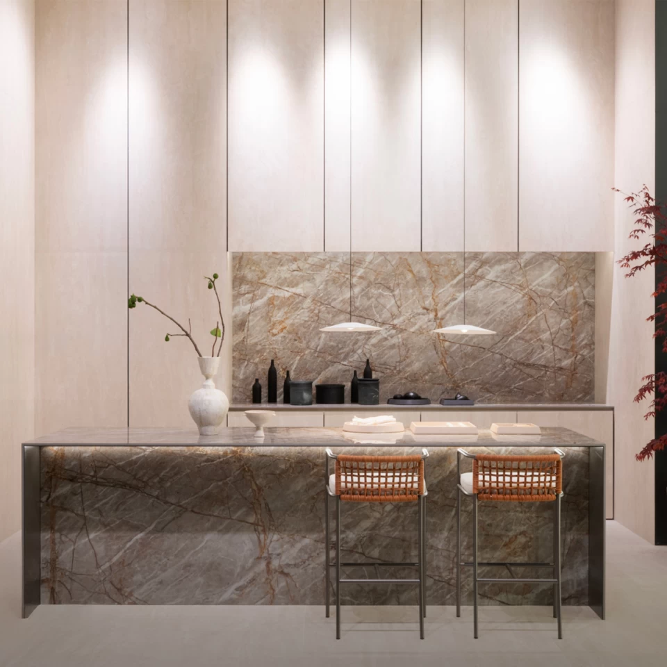 Modern kitchen with island in Atlas Plan marble-effect large slabs and minimalist stools, Milan Design Week