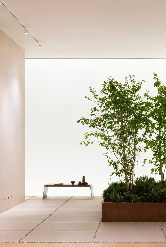 Outdoor installation with Atlas Plan large slab flooring and minimalist green area