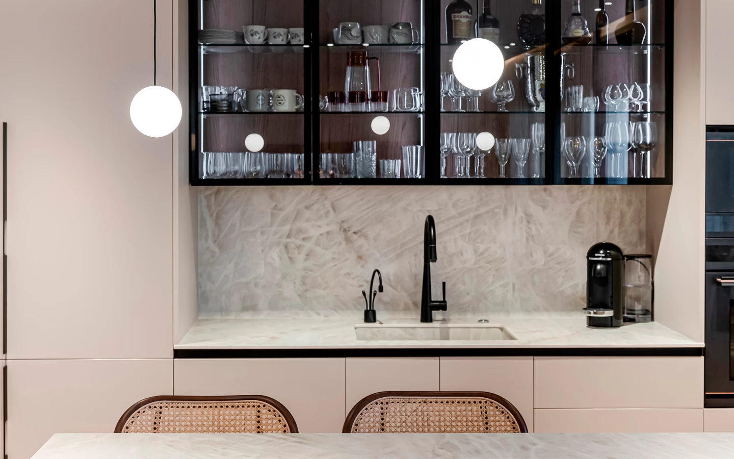 View of a kitchen with Crystal White countertop, enhanced by accent lighting that highlights the glossy surface and refined design.