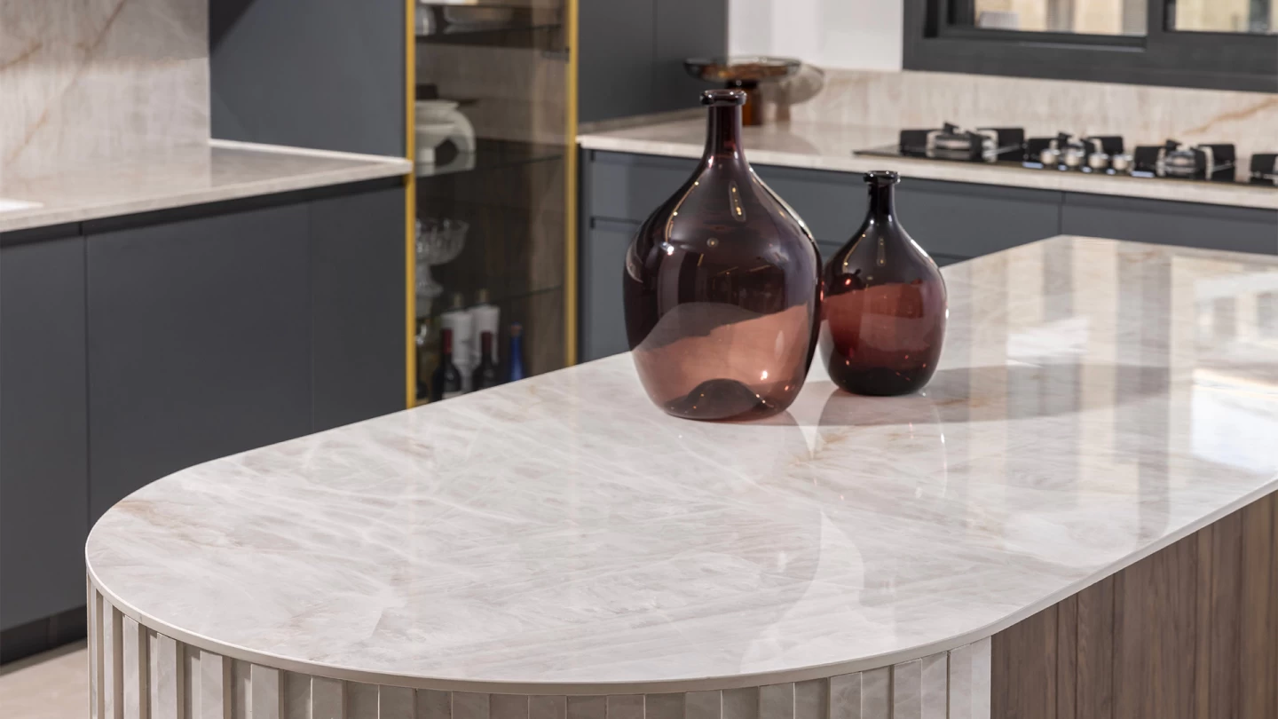 Detail of the elegant kitchen island with Crystal White marble-effect porcelain countertop