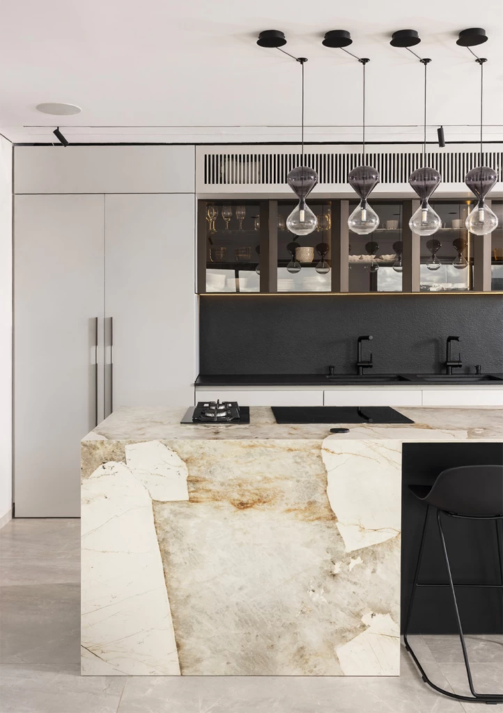 Refined kitchen with suspended ceiling lighting over Atlas Plan Desert Soul worktop